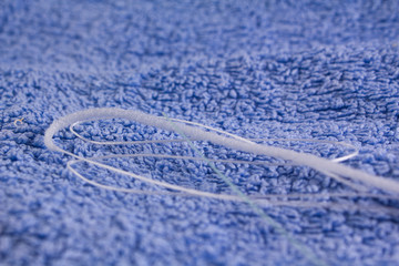 dental floss on a blue towel