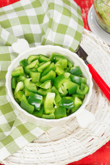 Bell Pepper.Chopped pepper in bowl and food processor on table