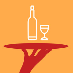 Hand of the waiter with a tray and a bottle and glass .