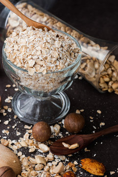 A Healthy Dry Oat meal with nut in a wooden spoon
