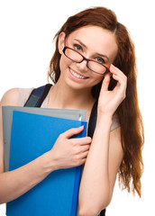 Young student girl is holding book