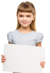 Fototapeta premium Little girl is holding blank banner