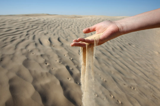 Woman Hand In The Sand