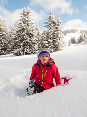 Fototapeta na wymiar little girl in snow with sledge