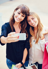 Two young women shopping at the mall taking a "selfie"