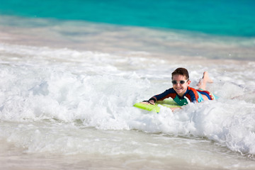 Boy swimming on boogie board