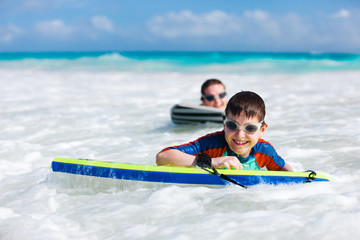 Mother and son surfing