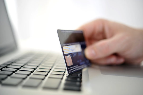 Man holding credit card in hand online shopping and banking