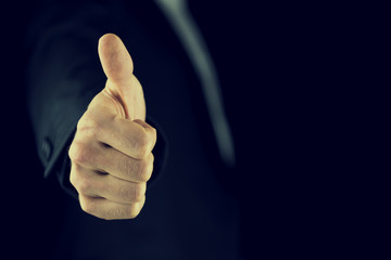 Thumbs up gesture of approval and success