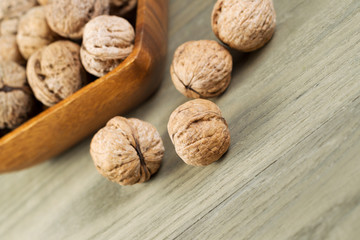 Close up of Whole Walnuts on Faded Wood