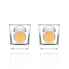 glass and old alarm clock isolated on white background