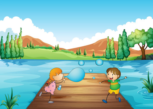 A young girl and boy playing with the bubbles