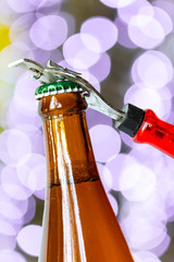Opening dark beer bottle with metal opener