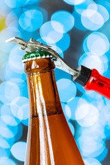 Opening dark beer bottle with metal opener