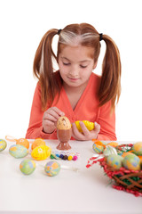 Fototapeta na wymiar Little girl painting easter eggs