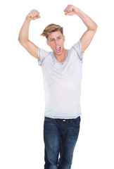 Fototapeta premium Young man celebrating with arms raised
