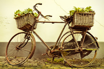 Fototapeta na wymiar Retro styled image of an old bicycle with baskets