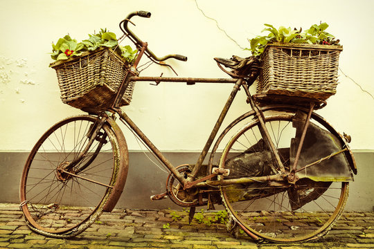 Retro styled image of an old bicycle with baskets