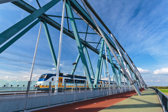 Dutch train passing a bridge in Nijmegen