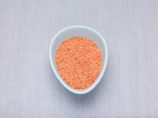 Red lentils, Petite crimson lentils in an oval bowl