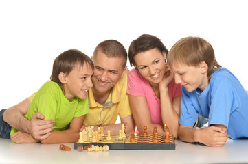 Happy family playing chess