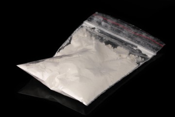 Cocaine in package on black background