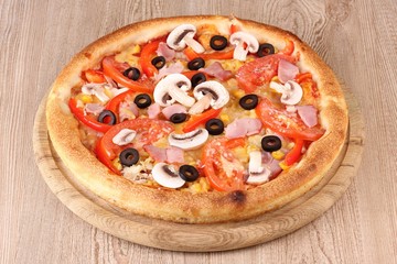 Aromatic pizza on wooden background