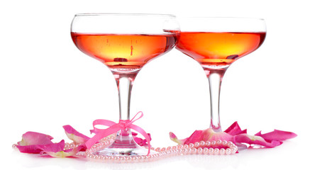 Composition with pink sparkle wine in glasses and  rose petals