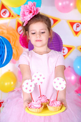 Fototapeta na wymiar Pretty little girl with cakes celebrate her birthday