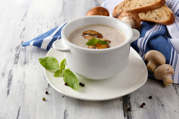 Mushroom soup in white pots, on napkin,  on wooden background