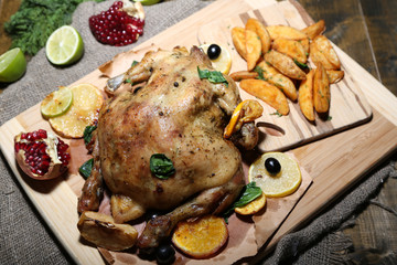 Whole roasted chicken with vegetables and fried potatoes