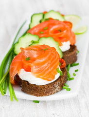 Canapes with salmon, onion and cucumber