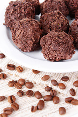 Delicious chocolates on plate close-up