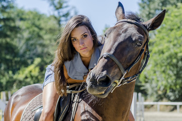 Obraz premium Young woman riding on the horse