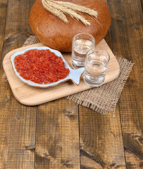 Composition with glasses of vodka  bread and red caviar
