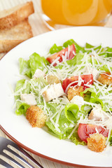 The Caesar salad with chicken and tomatoes