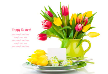 Easter eggs and blank for text in a plate, with tulips flowers o