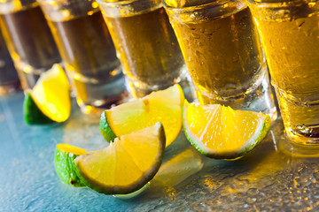 tequila and lime on glass table