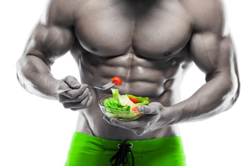 Shaped and healthy body man holding a fresh salad bowl,shaped ab