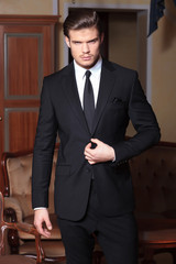 young business man with hand on jacket