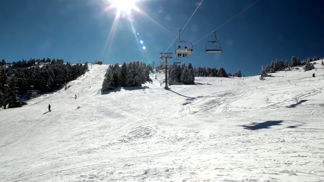 Ski Lift Moves Over The Snowy Mountain .Time Lapse.
