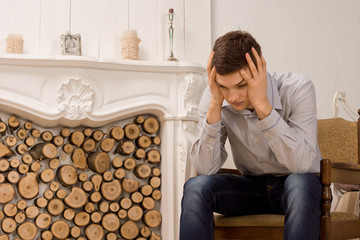 Worried young man with his head in his hands