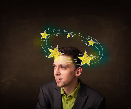 Young man with yellow stars circleing around his head