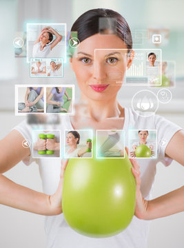 Sporty woman working out using modern virtual interface