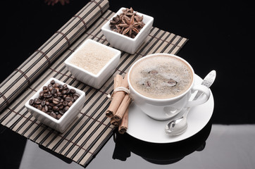 Obraz na płótnie Canvas Cup of coffee, spices and coffee beans