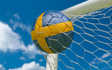 Sweden flag and soccer ball in goal net