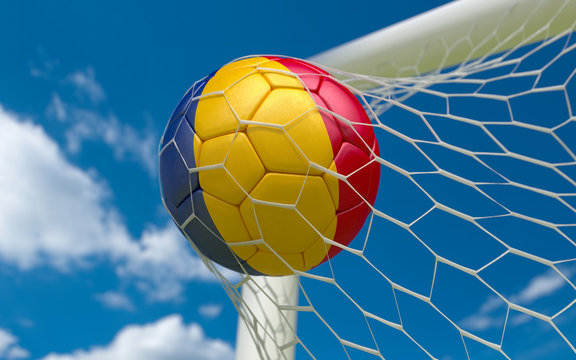 Romania flag and soccer ball in goal net
