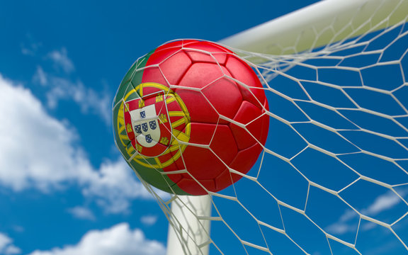 Portugal flag and soccer ball in goal net