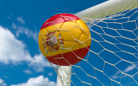 Spain flag and soccer ball in goal net