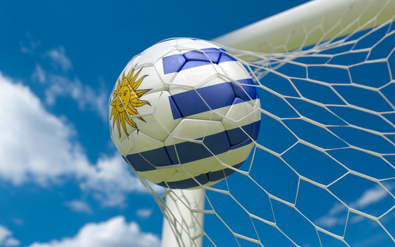 Uruguay flag and soccer ball in goal net